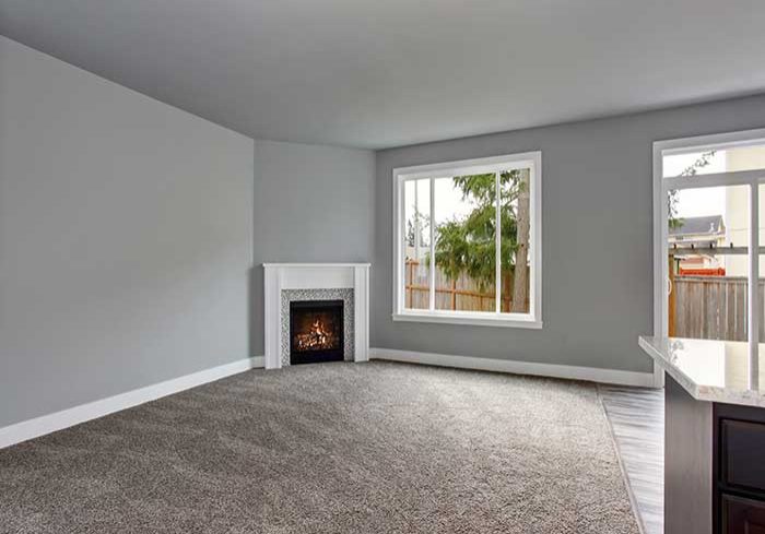 grey carpet around fireplace